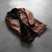 Styled Fit Perspective of Men's Cinnamon Distressed Leather Fur Ledermantel für Herren on Model - Natural Daylight Drape